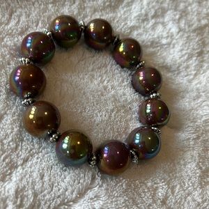 Garold Miller stretch bracelet
Incandescent brown/chrome-ish